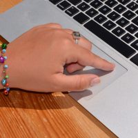 Hand on laptop touchpad Hand on laptop touchpad