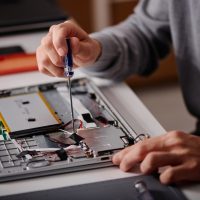 Professional Technician Repairing Laptop Professional Technician Repairing Laptop