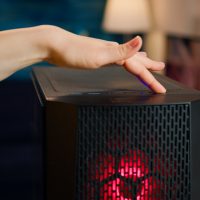 Woman gamer power on computer unit Woman gamer power on computer unit